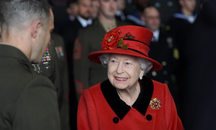 Queen Elizabeth II talks to military personnel during a visit to HMS Queen Elizabeth at HM Naval Base ahead of the ship's maiden deployment, in Portsmouth, England, on May 22, 2021. (Steve Parsons - WPA Pool / Getty Images)