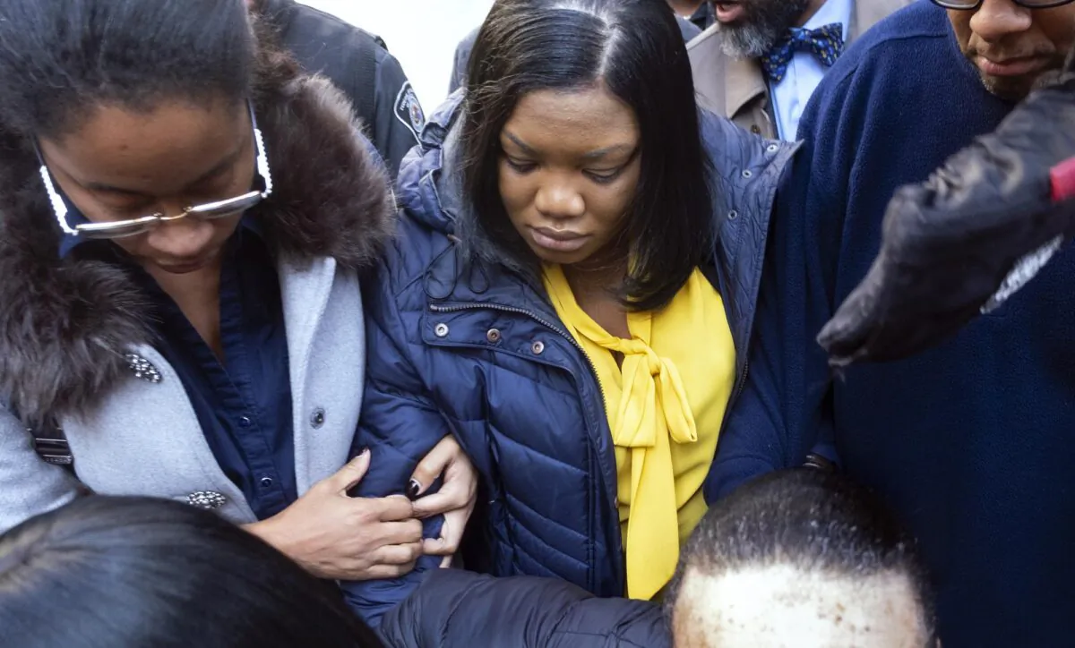Tova Noel, center in yellow blouse, a federal jail guard responsible for monitoring Jeffrey Epstein the night he killed himself, leaves federal court in New York, N.Y., on Nov. 25, 2019. (Craig Ruttle/AP Photo)
