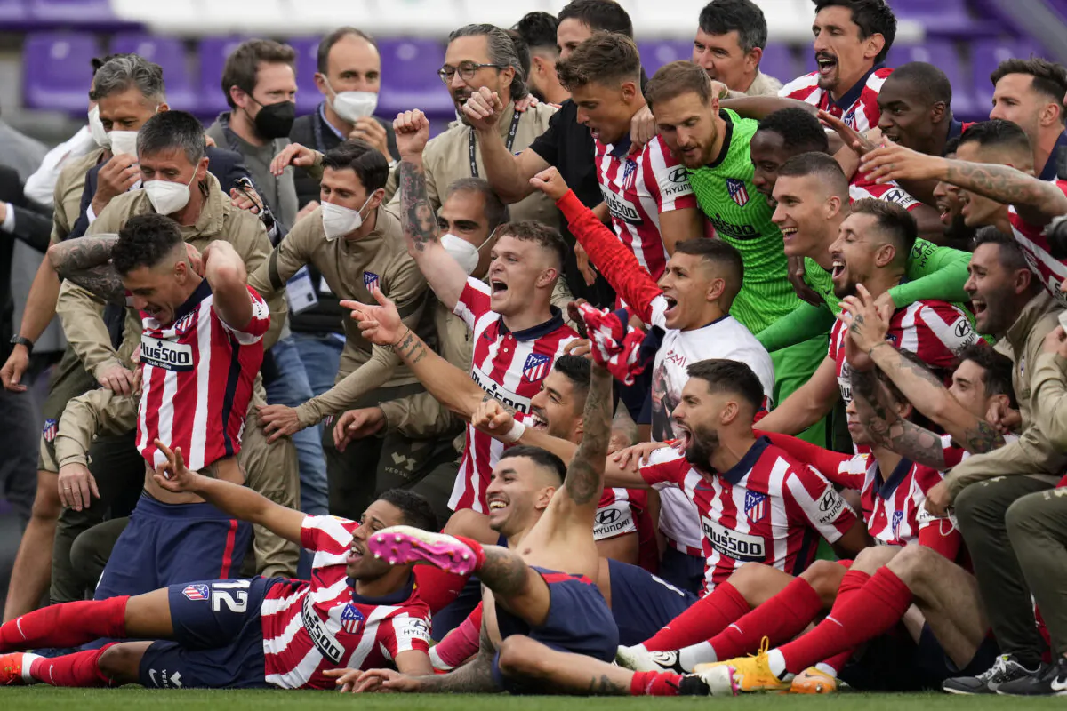 Atletico Madrid players celebrate at the end of the Spanish La Liga soccer match between Atletico Madrid and Valladolid at the Jose Zorrilla stadium in Valladolid, Spain, on May 22, 2021. (Manu Fernandez/AP Photo)