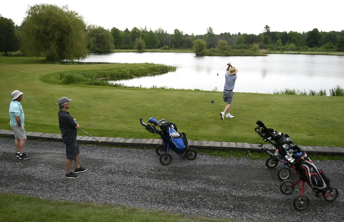 A golfer tees off at Loch March Golf and Country Club in Ottawa on May 22, 2021, as golf courses and other outdoor recreation facilities reopen in Ontario. (The Canadian Press/Justin Tang)