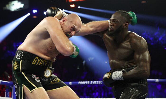 Deontay Wilder punches Tyson Fury during their Heavyweight bout for Wilder's WBC and Fury's lineal heavyweight title, at MGM Grand Garden Arena in Las Vegas, Nev., on Feb. 22, 2020. (Al Bello/Getty Images)