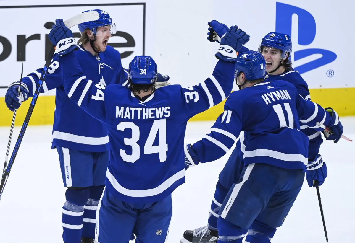 Toronto Maple Leafs defenseman Rasmus Sandin (38) celebrates his goal against the Montreal Canadiens with Auston Matthews (34), Zach Hyman (11) and Mitchell Marner (16) during the second period of Game 2 of an NHL hockey Stanley Cup first-round playoff series, in Toronto, Canada, on May 22, 2021. (Nathan Denette/The Canadian Press via AP)