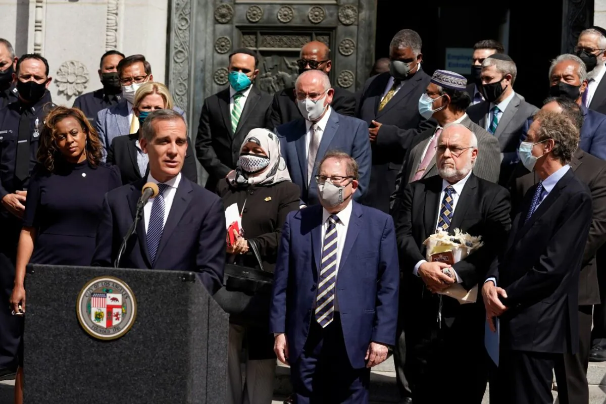 Los Angeles Mayor Eric Garcetti, at podium, speaks in front of civic and faith leaders outside City Hall in Los Angeles, Calif., on May 20, 2021. (Marcio Jose Sanchez/File/AP Photo)