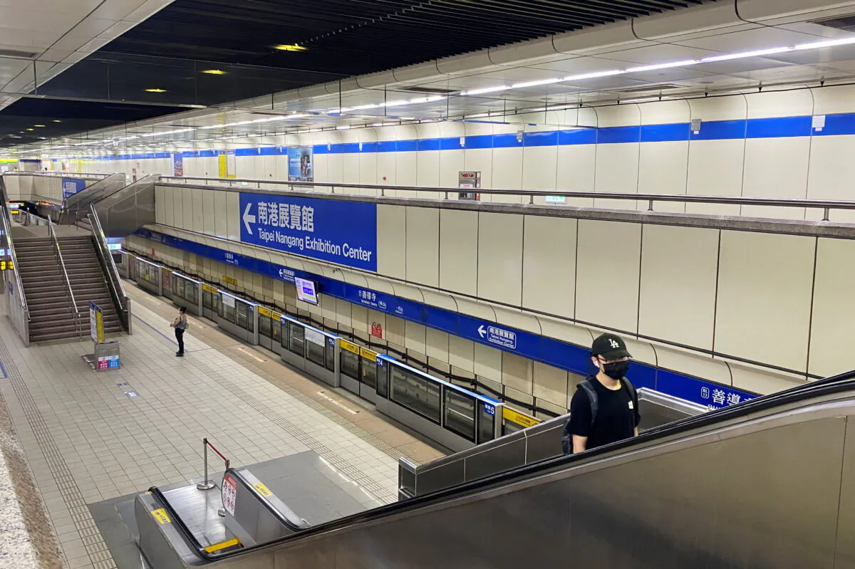 A passenger wearing a mask rides an escalator at a metro station following the recent spike in COVID-19 virus infections in Taipei, Taiwan, on May 22, 2021. (Ben Blanchard/Reuters)