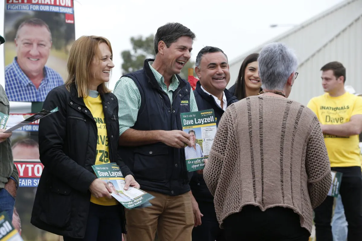 Dave Layzell for NSW Upper Hunter electorate greets voters alongside Deputy Premier John Barilaro (third from left) on polling day at the Muswellbrook Indoor Sports Centre in Muswellbrook, Australia on May 22, 2021. (AAP Image/Darren Pateman)