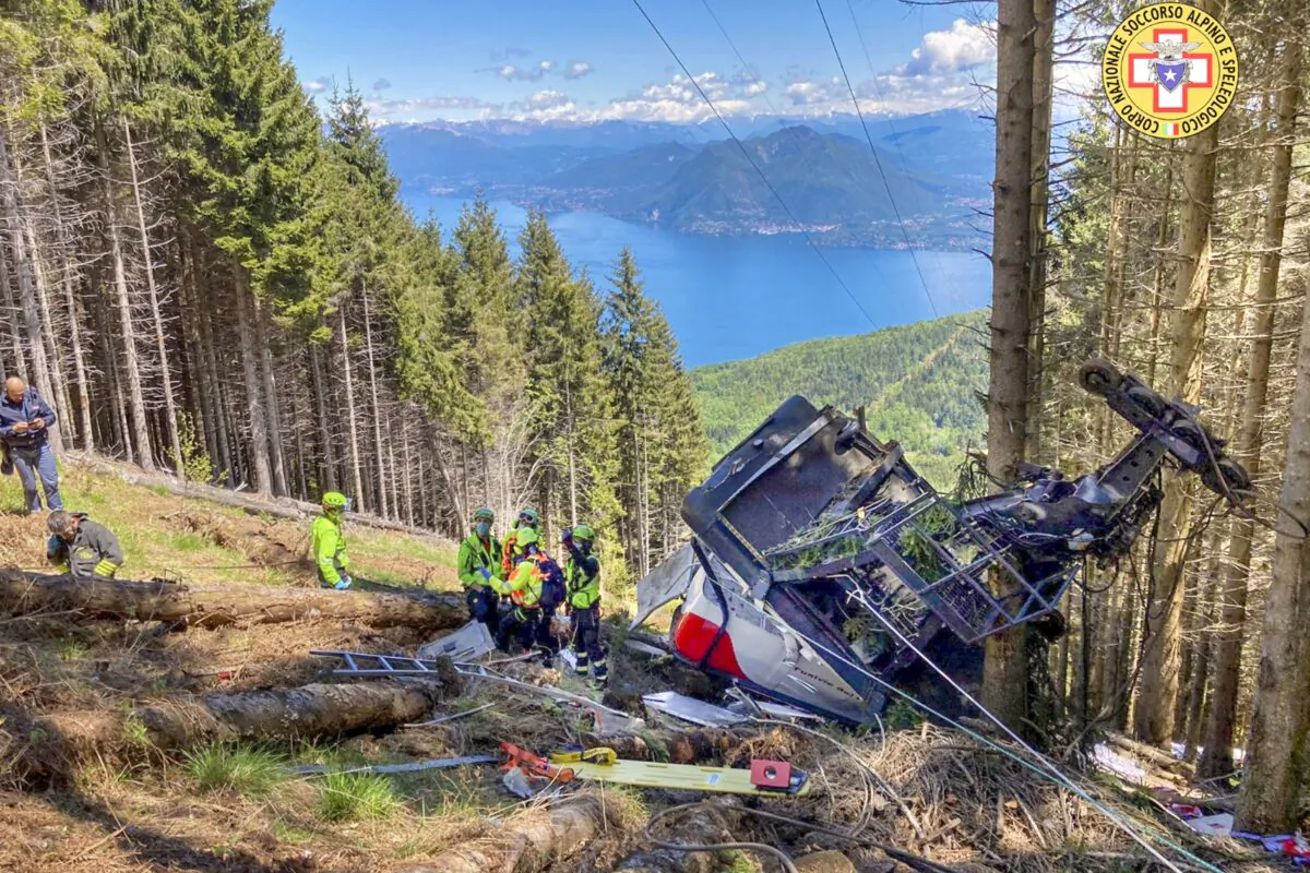 Rescuers work by the wreckage of a cable car after it collapsed near the summit of the Stresa-Mottarone line in the Piedmont region, northern Italy, on May 23, 2022. (Soccorso Alpino e Speleologico Piemontese via AP)