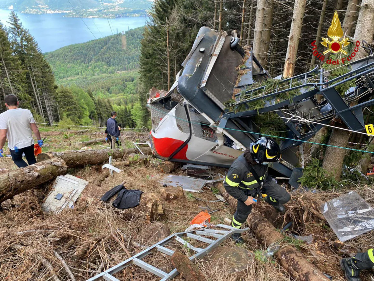 Rescuers work by the wreckage of a cable car after it collapsed near the summit of the Stresa-Mottarone line in the Piedmont region, northern Italy, on May 23, 2021. (Italian Vigili del Fuoco Firefighters via AP)