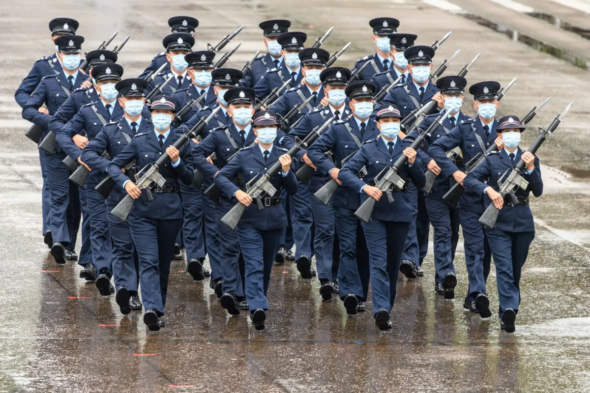 Police officers perform a new goose-stepping march, the same style used by police and troops on the Chinese mainland, at the city's police college during an open day to mark the National Security Education Day in Hong Kong on April 15, 2021. (ANTHONY WALLACE/AFP via Getty Images)