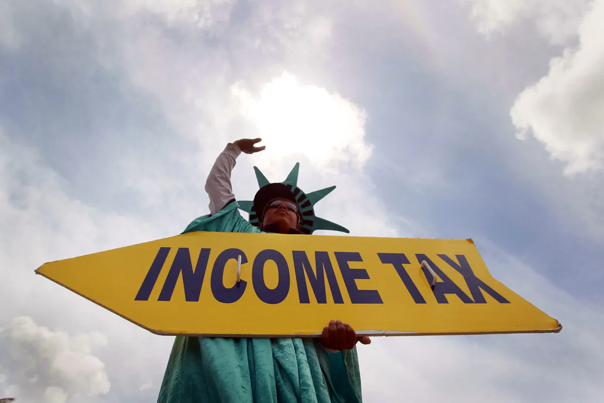 A man holding a sign advertising a tax preparation office in Miami, Fla., on April 14, 2010. (Joe Raedle/Getty Images)