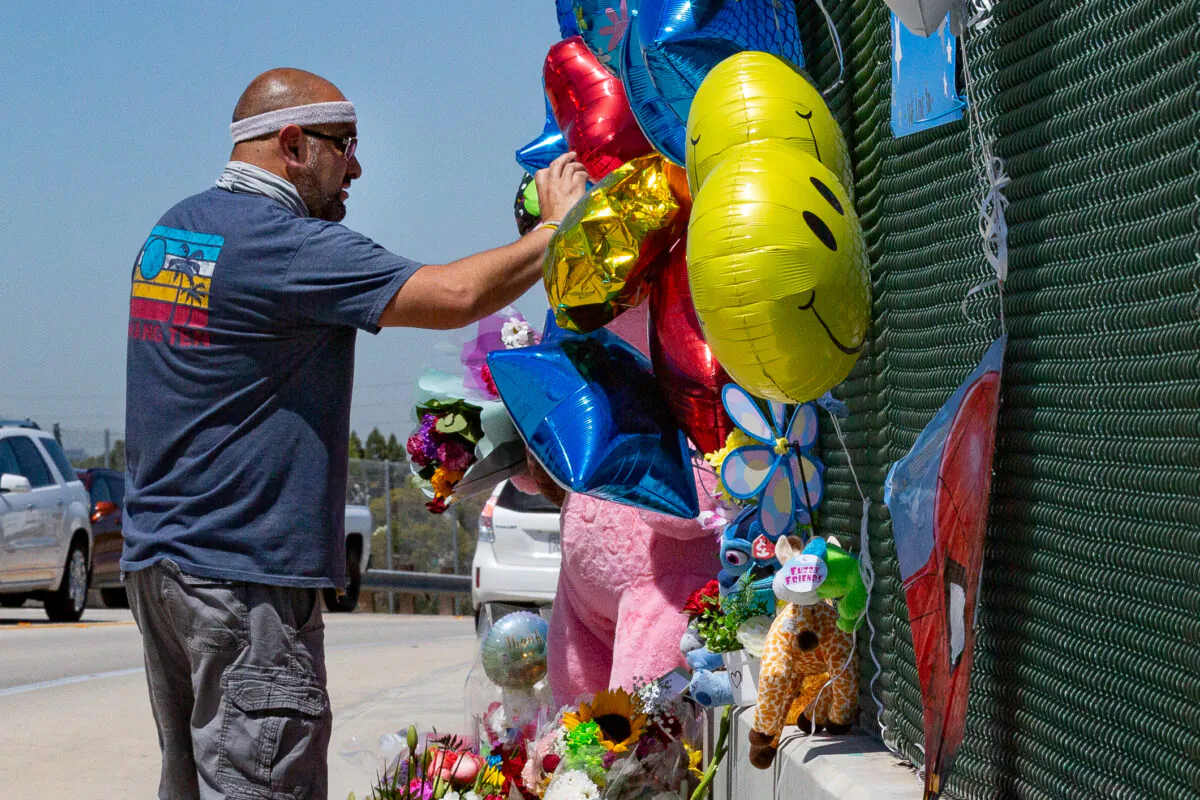 Local residents place items along the Walnut Avenue overpass bridge over the 55 Freeway in Orange, Calif., on May 24, 2021. (John Fredricks/The Epoch Times)