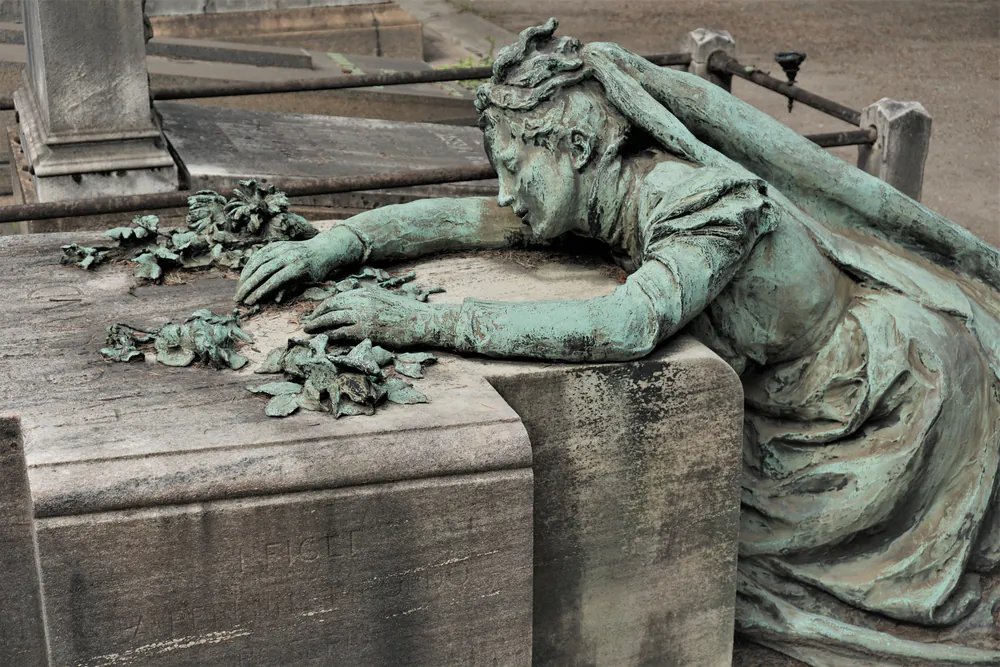 A.E. Housman’s poem “With Rue My Heart Is Laden” expresses the sorrow of lost youth. Sculpture in Milan, Italy’s Monumental Cemetery. (Alicja Graczyk/Shutterstock)