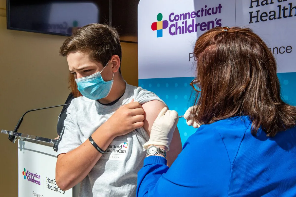 Max Zito, age 13, is inoculated by Nurse Karen Pagliaro at Hartford Healthcares mass vaccination center at the Connecticut Convention Center in Hartford, Conn. on May 13, 2021. (Joseph Prezioso/AFP via Getty Images)
