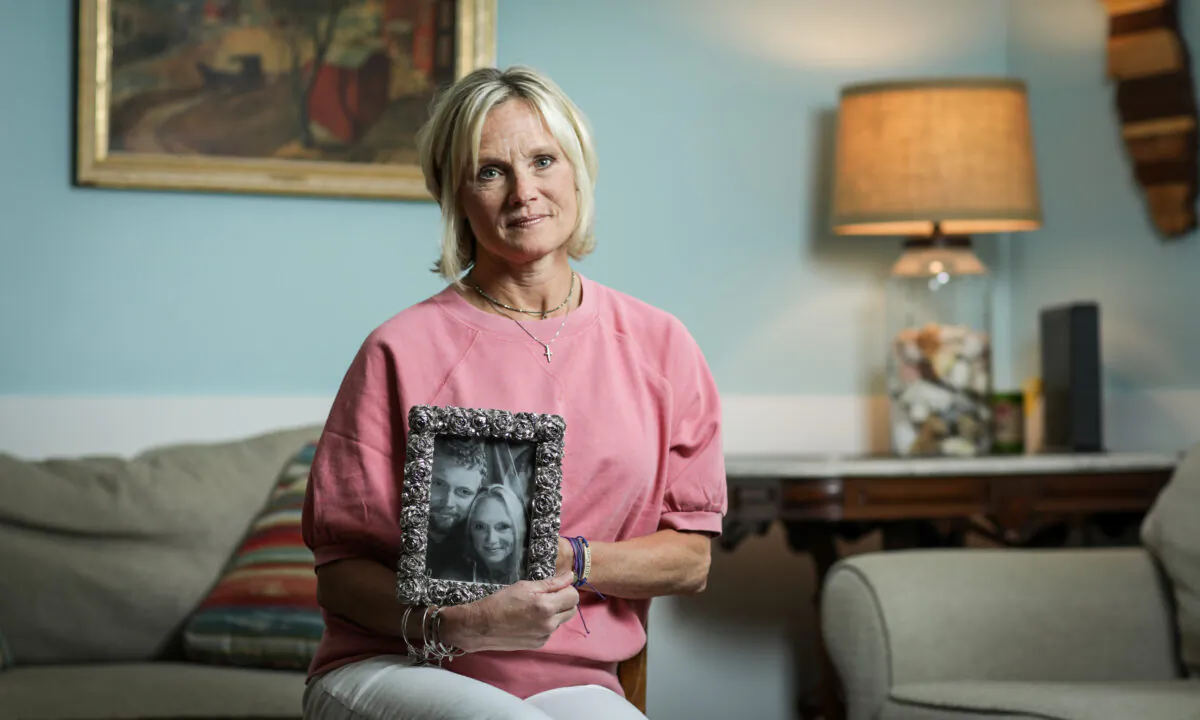 Michele Holbrook holds a photo of her son, Chandler Cook, who died of an overdose, at her home in Fernandina Beach, Fla., on May 19, 2021. (Samira Bouaou/The Epoch Times)