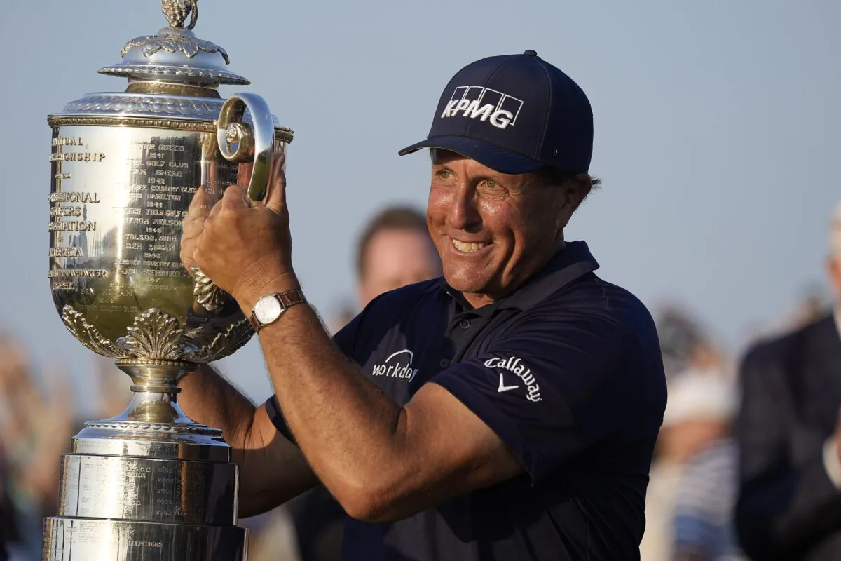 Phil Mickelson holds the Wanamaker Trophy after winning the PGA Championship golf tournament on the Ocean Course in Kiawah Island, S.C., on May 23, 2021. (David J. Phillip/AP Photo)