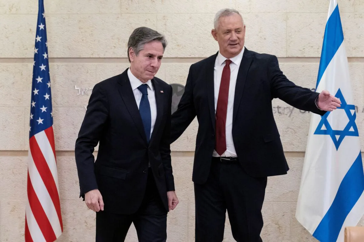 U.S. Secretary of State Antony Blinken and Defense Minister Benny Gantz move to take their seats before their meeting at the Ministry of Foreign Affairs, in Jerusalem on May 25, 2021. (Alex Brandon/Pool via Reuters)