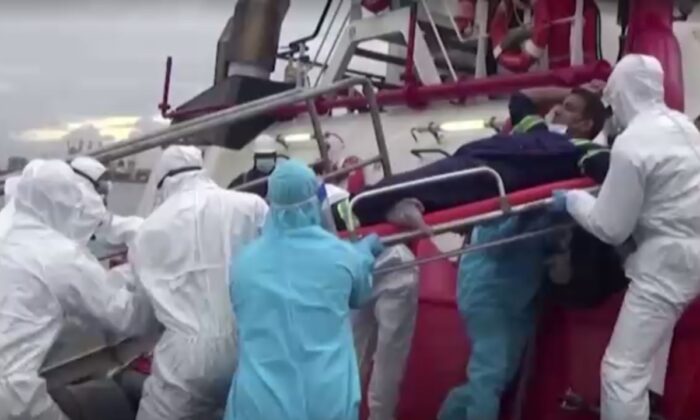 Rescuers evacuate all crew from a vessel as a fire on board intensified, off the coast of Sri Lanka, on May 25, 2021. (Screenshot/Reuters)