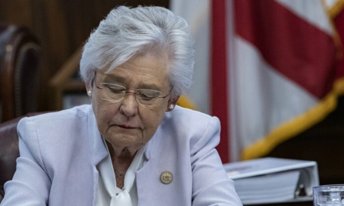 Alabama Gov. Kay Ivey signs a bill into law to ban vaccine passports on May 24, 2021. (Courtesy of Gov. Kay Ivey's Office)

