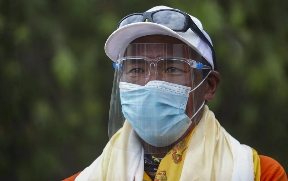 Veteran Sherpa guide Kami Rita who returned  from the mountains on a helicopter arrives at the airport in Kathmandu, Nepal, on May 25, 2021. (Bikram Rai/AP Photo)