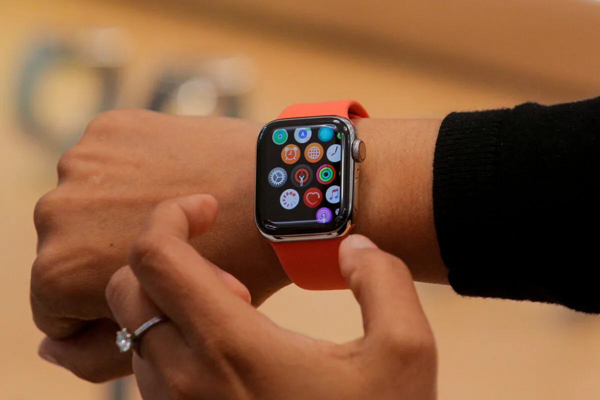 An Apple Store employee shows the Series 5 Apple Watch during the preview of the redesigned and reimagined Apple Fifth Avenue store in New York on Sept. 19, 2019. (Brendan McDermid/Reuters File Photo)