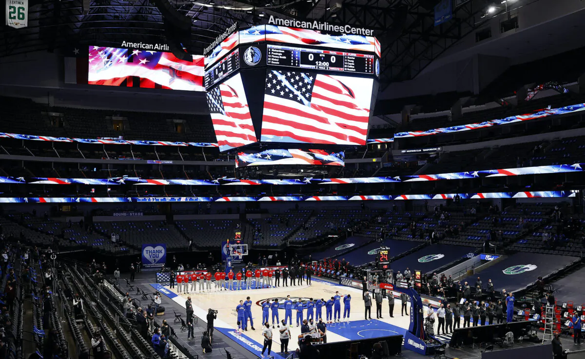 The Dallas Mavericks and the Atlanta Hawks stand for the National Anthem prior to tipoff of their NBA game at American Airlines Center in Dallas, Texas, on Feb. 10, 2021. (Tom Pennington/Getty Images)