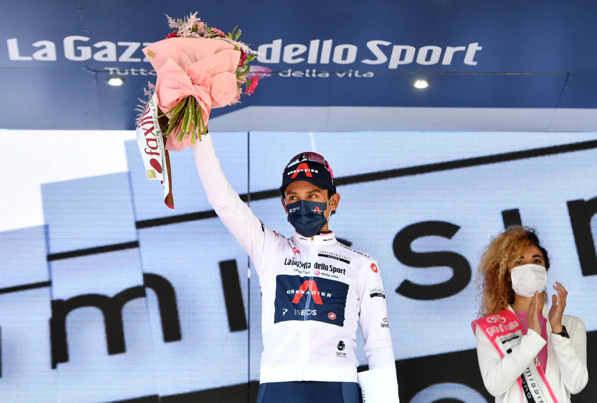 Ineos Grenadiers rider Egan Arley Bernal Gomez of Colombia celebrates wearing the maglia bianca on the podium after stage 17 in Canazei to Sega di Ala, Italy on May 26, 2021. (Jennifer Lorenzini/Reuters)