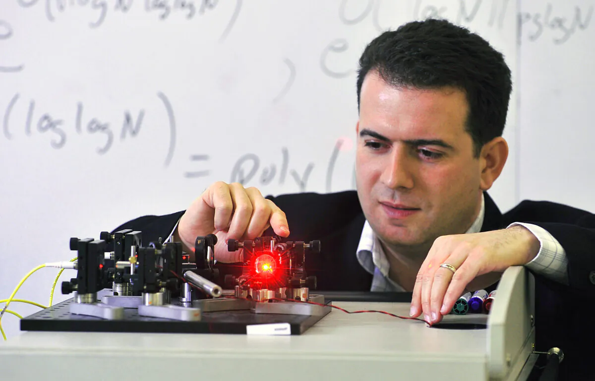 University of Waterloo quantum computing researcher Michele Mosca demonstrates a Mach-Zender interferometer. (Institute for Quantum Computing)