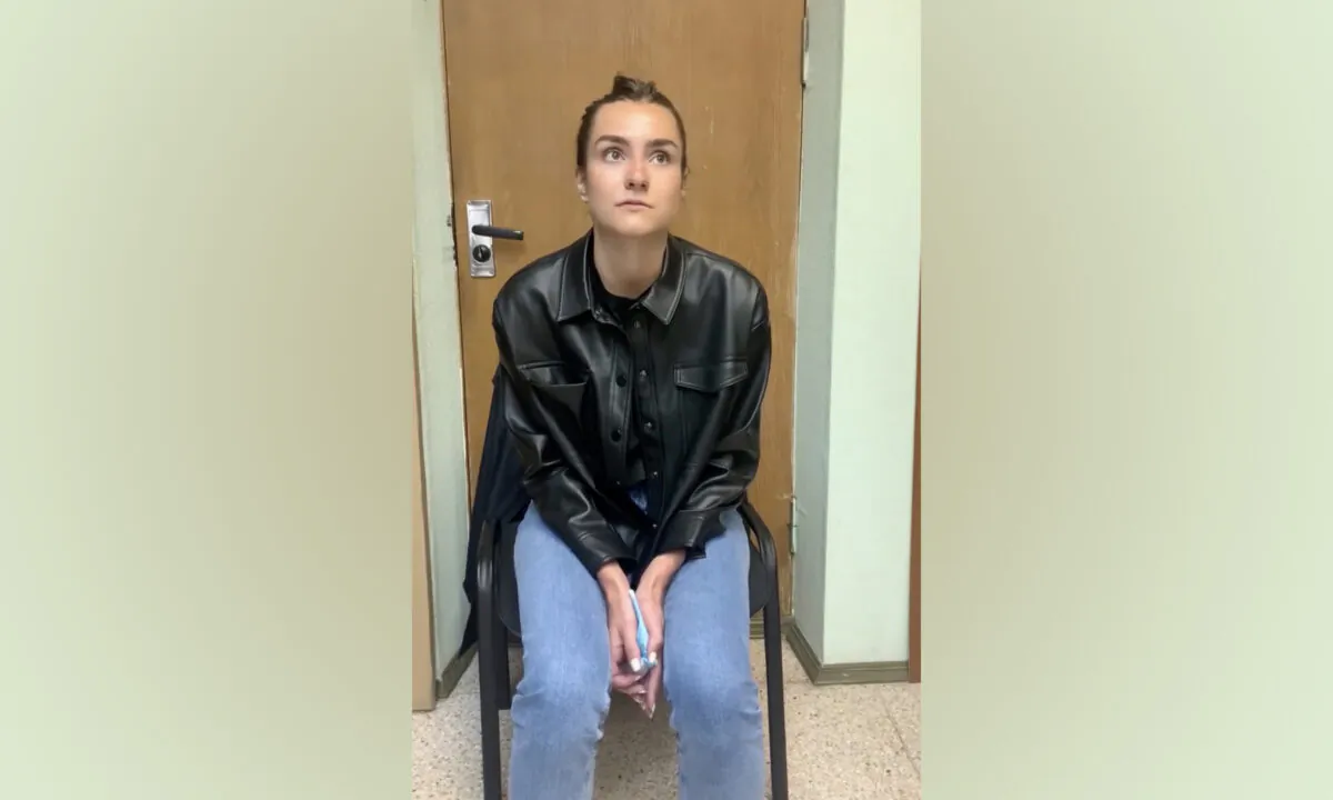A view shows a woman who names herself Sofia Sapega and admits she is the editor of a Telegram channel "Chernaya Kniga Belarusi" (Black Book of Belarus) which discloses the personal information of internal affairs officers, at an unknown location, in this still image taken from video released May 25, 2021. (Telegram Channel "Zheltye Slivy"/Reuters TV via Reuters)