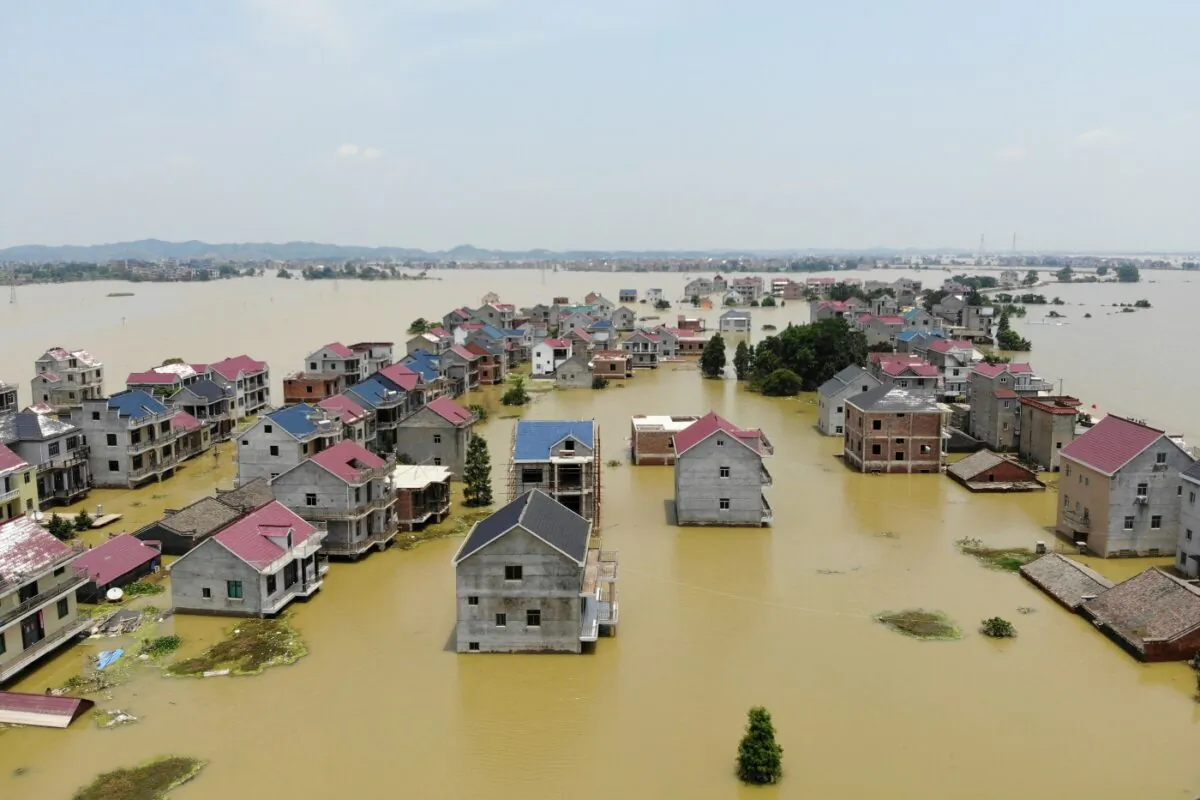 Buildings and farmlands are seen partially submerged in floodwaters following heavy rainfall in Poyang county of Jiangxi province, China, on July 17, 2020. (China Daily via Reuters)