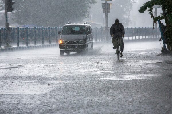 man-pedals-through-rain