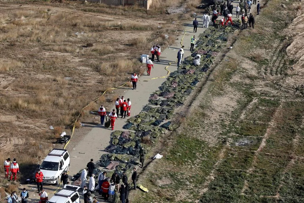Bodies of the victims of a Ukrainian plane crash are collected by rescue team at the scene of the crash in Shahedshahr, southwest of the capital Tehran, Iran, on Jan. 8, 2020. (AP, Ebrahim Noroozi/The Canadian Press)