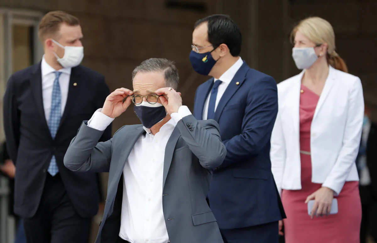 German Foreign Minister Heiko Maas (second left) adjusts his glasses prior to a group photo of EU foreign ministers in Lisbon on May 27, 2021. (Armando Franca/AP Photo)