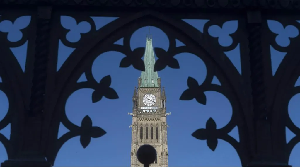 The Peace Tower is framed through a gate on Parliament Hill in Ottawa on January 21, 2016. (The Canadian Press/Adrian Wyld)