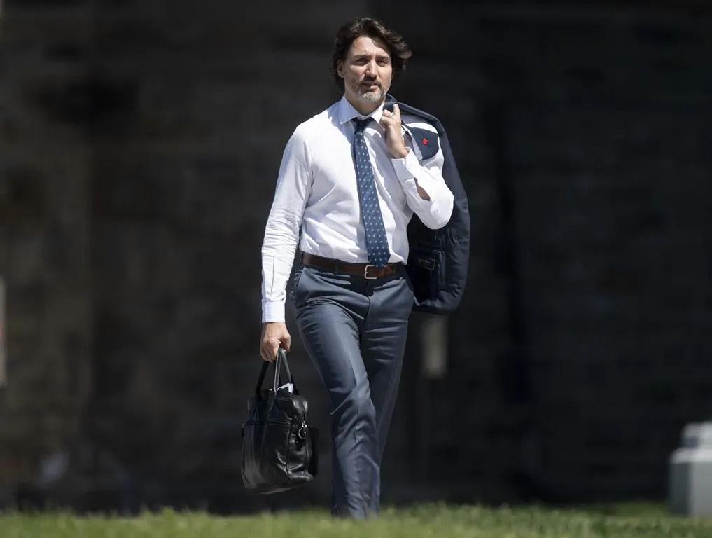Prime Minister Justin Trudeau walks between buildings in the Parliamentary precinct in Ottawa on May 28, 2021. (Adrian Wyld/The Canadian Press)