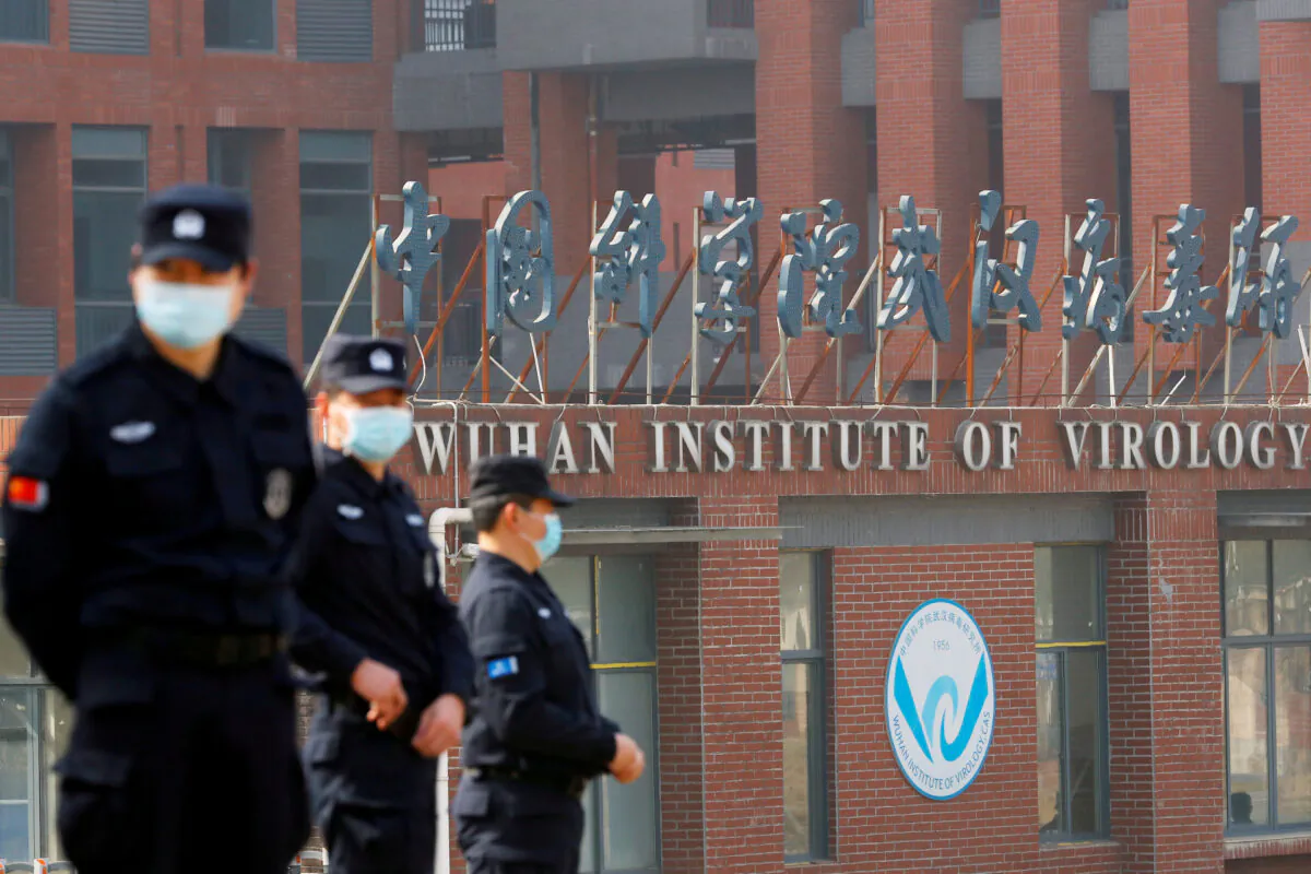 Security personnel keep watch outside the Wuhan Institute of Virology during the visit by the World Health Organization team tasked with investigating the origins of COVID-19, in Wuhan, Hubei Province, China, on Feb. 3, 2021. (Thomas Peter/Reuters)