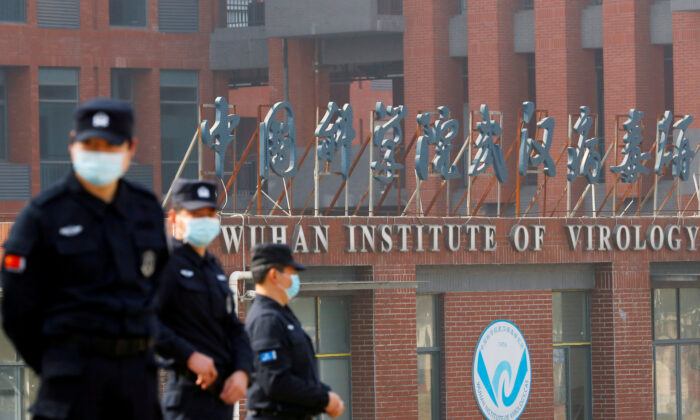 Security personnel keep watch outside the Wuhan Institute of Virology during the visit by the World Health Organization team tasked with investigating the origins of COVID-19, in Wuhan, Hubei Province, China, on Feb. 3, 2021. (Thomas Peter/Reuters)