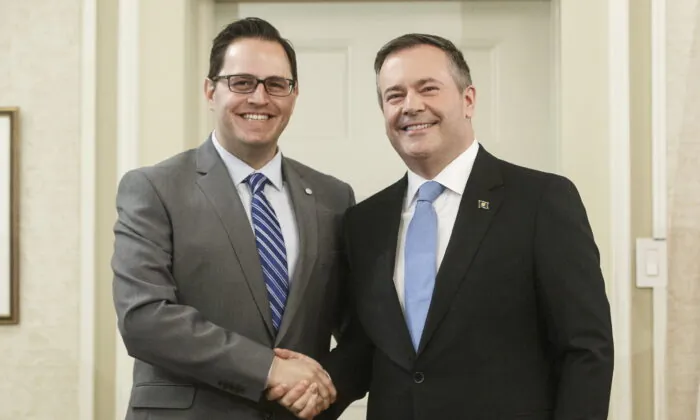 Alberta premier Jason Kenney shakes hands with Demetrios Nicolaides, Minister of Advanced Education after being sworn into office, in Edmonton on April 30, 2019. (The Canadian Press/Jason Franson)