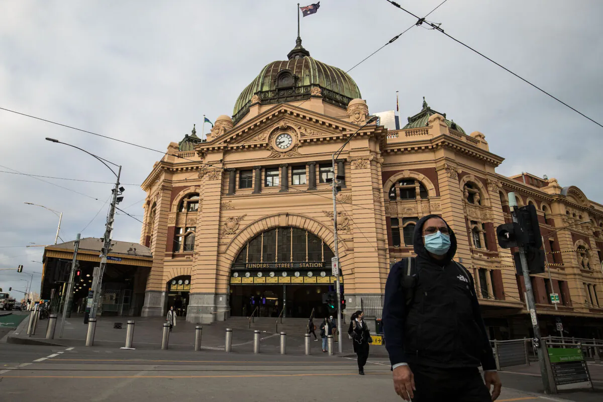 A man crosses the normally busy intersection of Flinders street and Swanston streets in Melbourne, Australia on May 28, 2021. (Darrian Traynor/Getty Images)