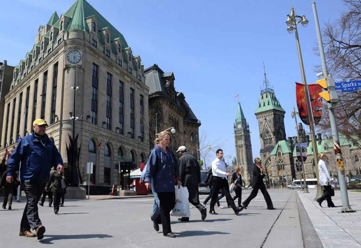 Pedestrians cross Elgin Street in view of Parliament Hill in Ottawa in a file photo. (The Canadian Press/Sean Kilpatrick)