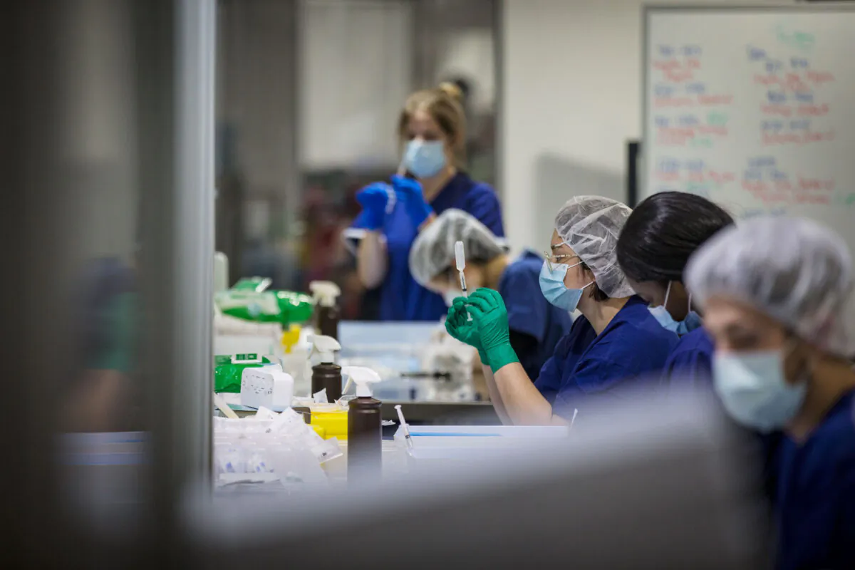 Staff are seen preparing vaccine doses inside the Melbourne Exhibition Centre COVID-19 Vaccination Centre in Melbourne, Australia on May 28, 2021. (Darrian Traynor/Getty Images)