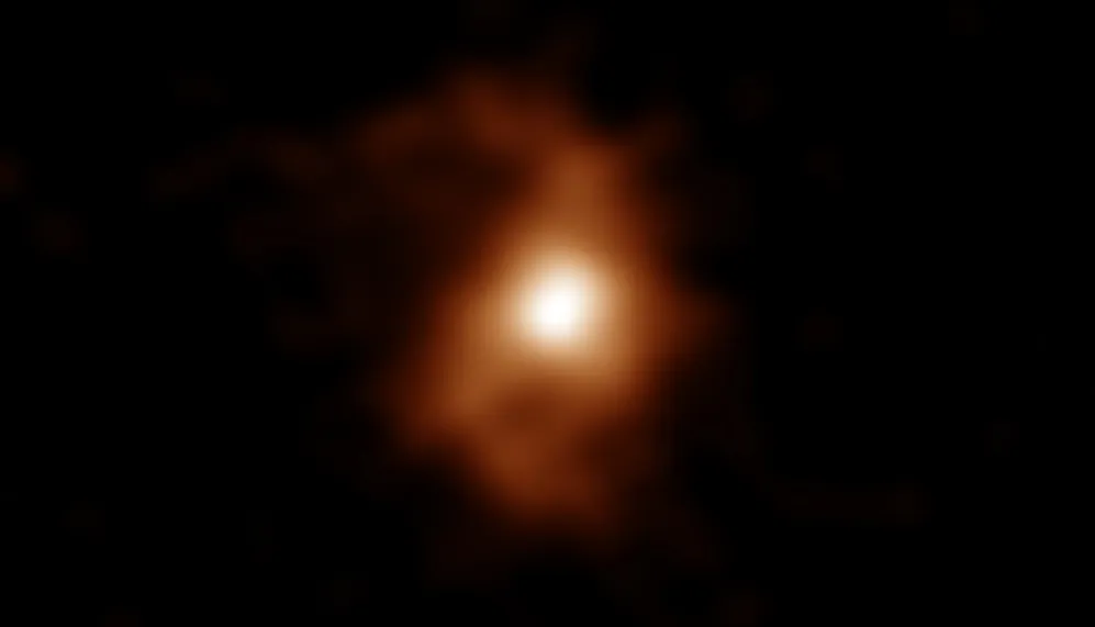 An ALMA image of the galaxy BRI 1335-0417 as it appeared 12.4 billion years ago. Spiral arms are visible on both sides of the compact, bright area in the center of the galaxy. (ALMA (ESO/NAOJ/NRAO), T. Tsukui & S. Iguchi)