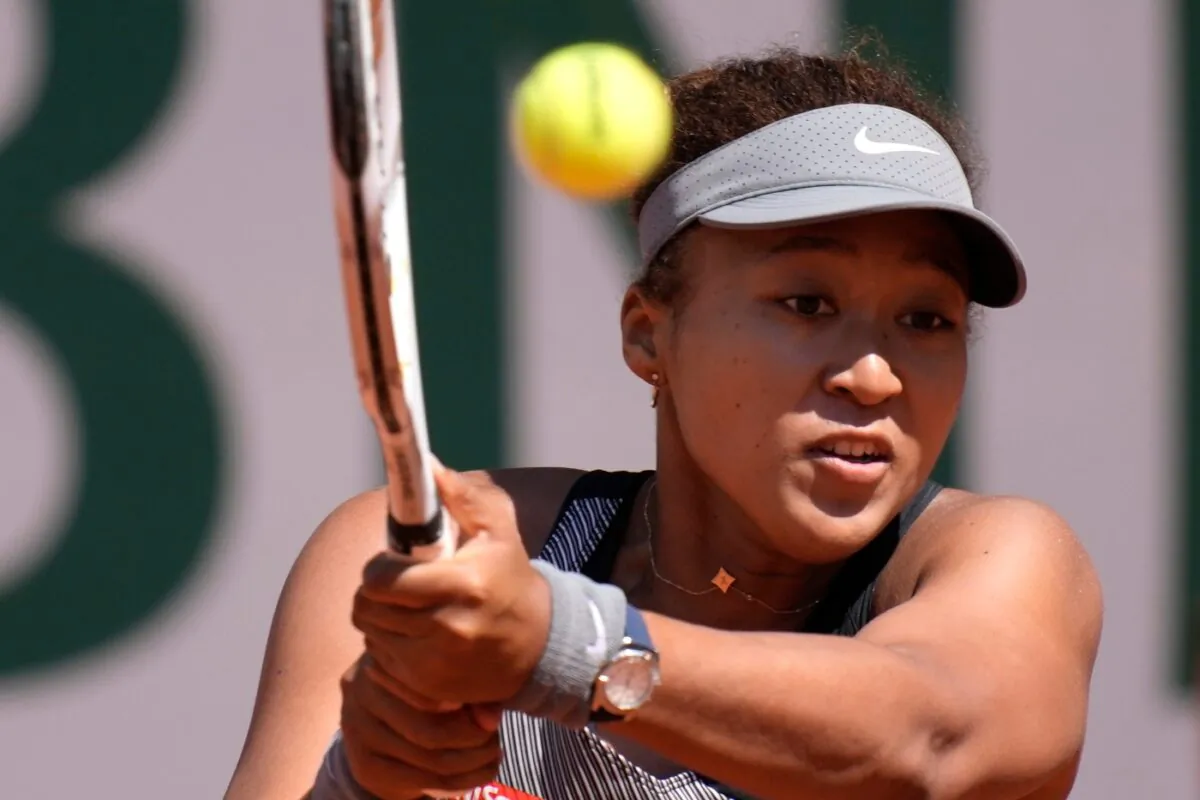 Japan's Naomi Osaka returns the ball to Romania's Patricia Maria Tig during their first round match of the French Open tennis tournament at the Roland Garros stadium, in Paris, France, on May 30, 2021. (Christophe Ena/AP Photo)