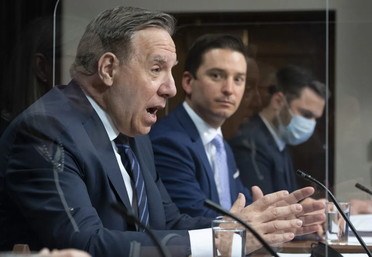 Quebec Premier Francois Legault (L) speaks during a news conference after tabling a reform on language law at the legislature in Quebec City, Canada, on May 13, 2021. (The Canadian Press/Jacques Boissinot)