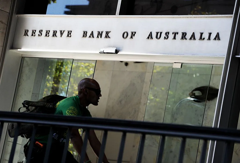 A bike courier rides past the entrance to the Reserve Bank of Australia (RBA) in Sydney's central business district on April 2, 2013. (Greg Wood/AFP via Getty Images)