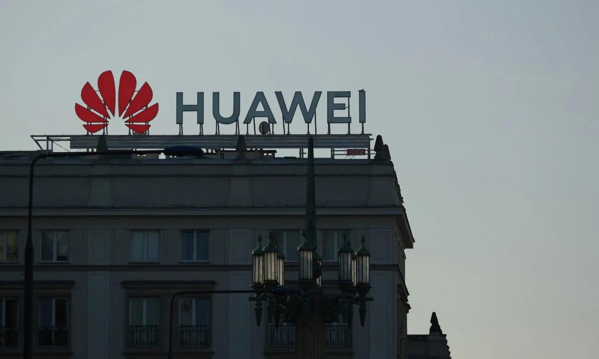 A sign advertising Chinese telecoms equipment manufacturer Huawei stands on an apartment building in Warsaw, Poland, on Oct. 11, 2019. (Sean Gallup/Getty Images)
