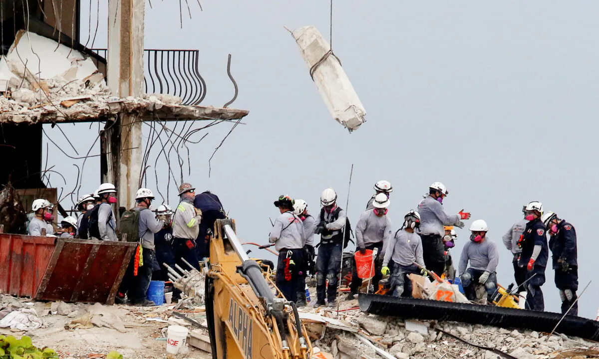 Emergency workers conduct search and rescue efforts at the site of a partially collapsed residential building in Surfside, near Miami Beach, Fla., on June 30, 2021. (Joe Skipper/Reuters)