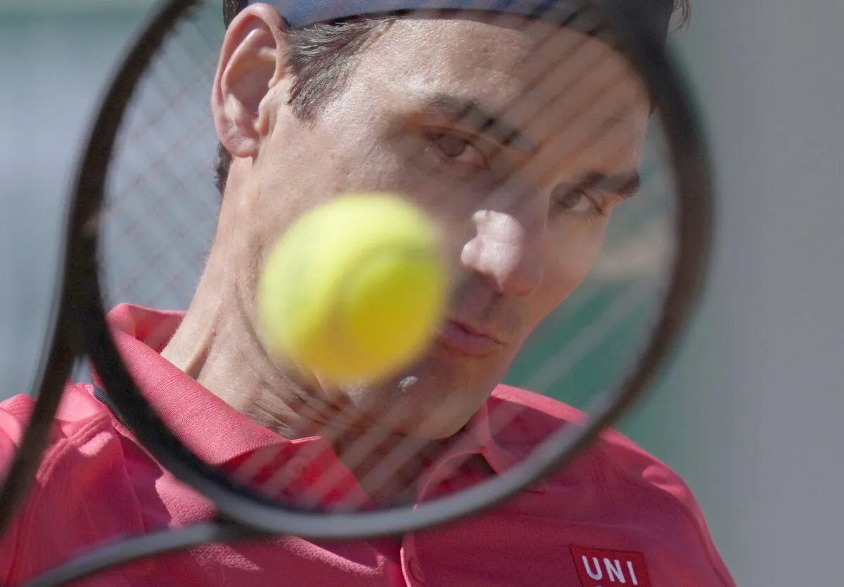 Switzerland's Roger Federer plays a return to Uzbekistan's Denis Istomin during their first round match on day two of the French Open tennis tournament at Roland Garros in Paris, France, Monday, May 31, 2021. (Thibault Camus/AP Photo/)