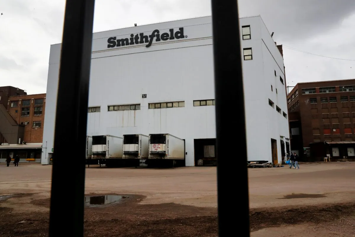 Workers walk out of Smithfield Foods pork plant in Sioux Falls, S.D., on April 16, 2020. (Shannon Stapleton/Reuters)
