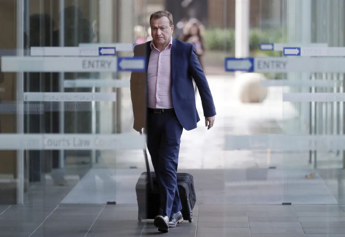 Andrew Cooper, founder and president of libertarian group LibertyWorks, arrives at Federal Court in Sydney on May 6, 2021. (AP Photo/Rick Rycroft)
