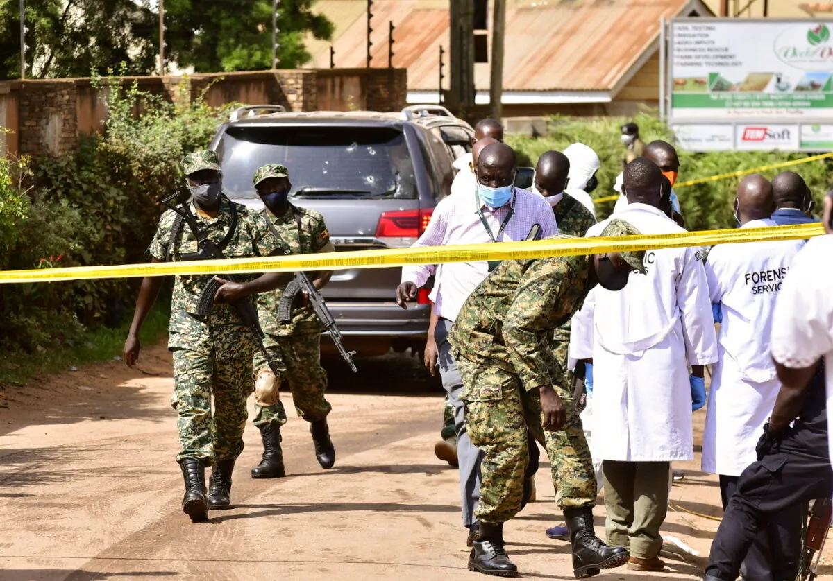 Security forces and forensic experts secure the scene of an attempted assassination on Ugandan minister of works and transport General Katumba Wamala in the suburb of Kiasasi within Kampala, Uganda, on June 1, 2021. (Abubaker Lubowa/Reuters)