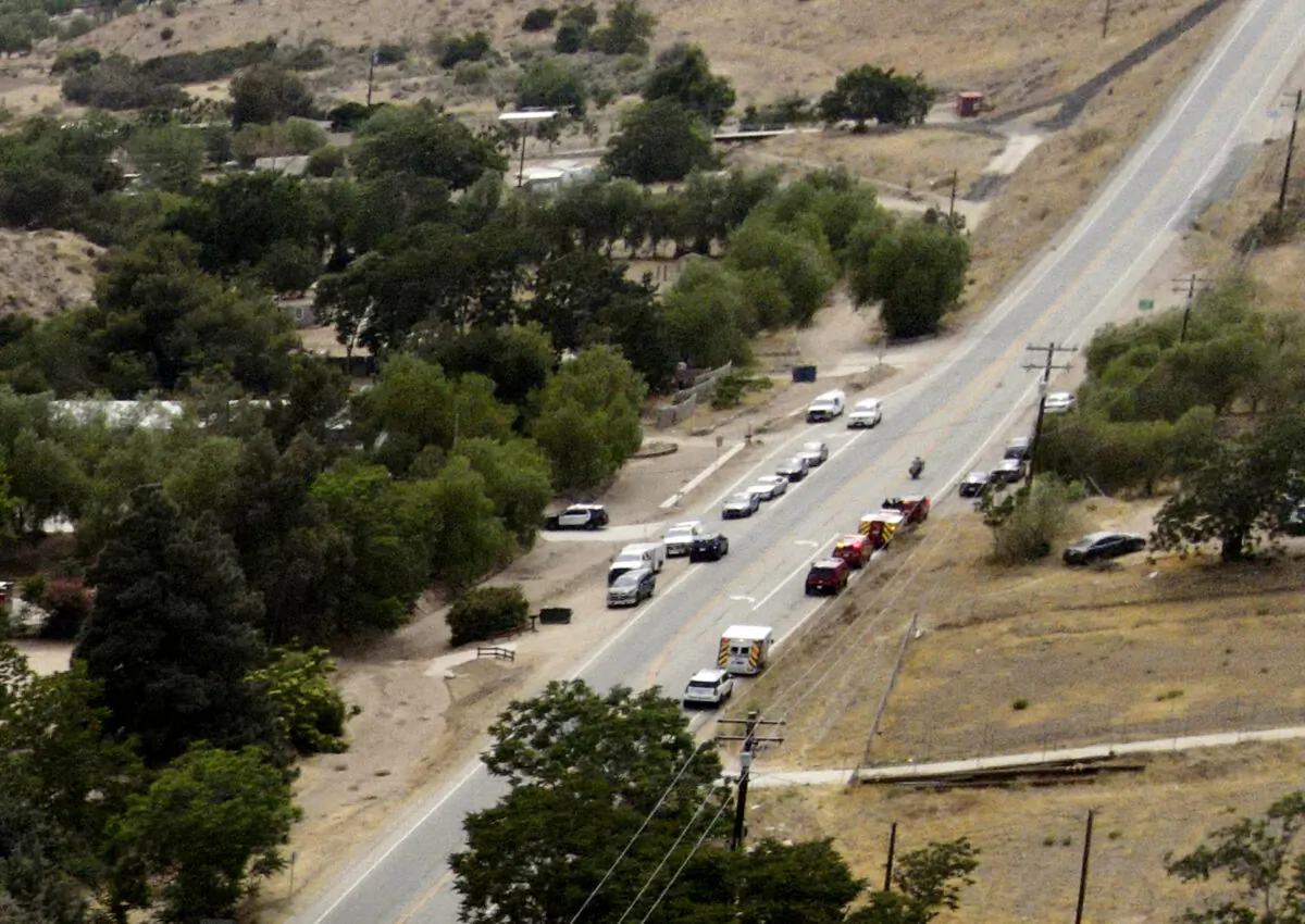 Law enforcement personnel close off a road during an investigation of a shooting at Fire Station 81 in Santa Clarita, Calif., on June 1, 2021. (David Swanson/AP Photo)